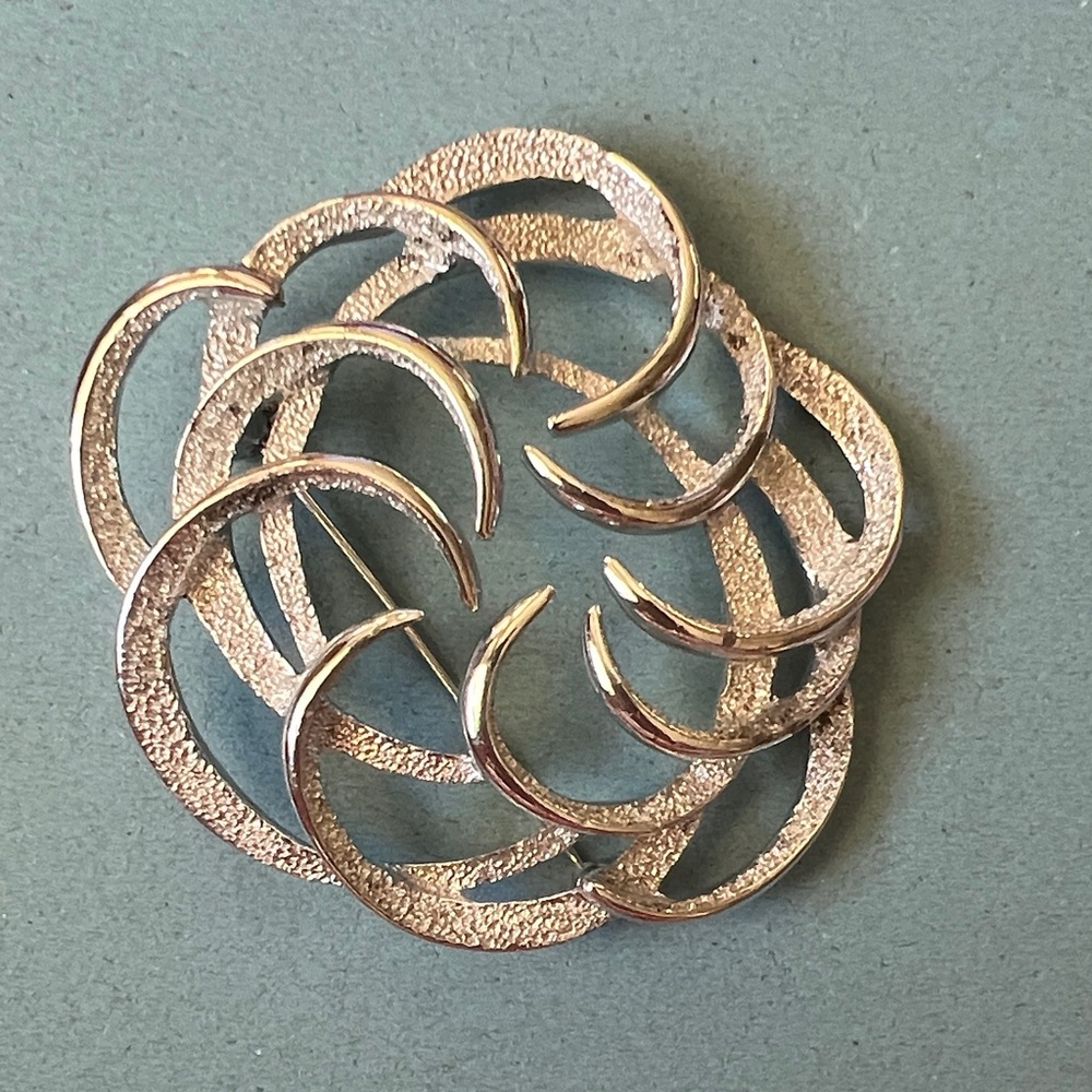 Tailored Swirl" brooch produced by Sarah Coventry.